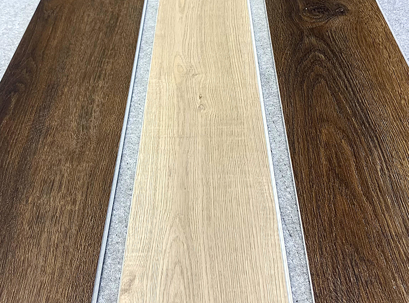 three samples of vinyl laminate floor boards on display which is used to create vinyl stair nosings